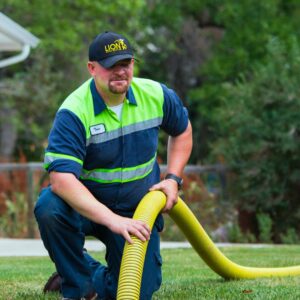 lion home service employee pumping septic tank